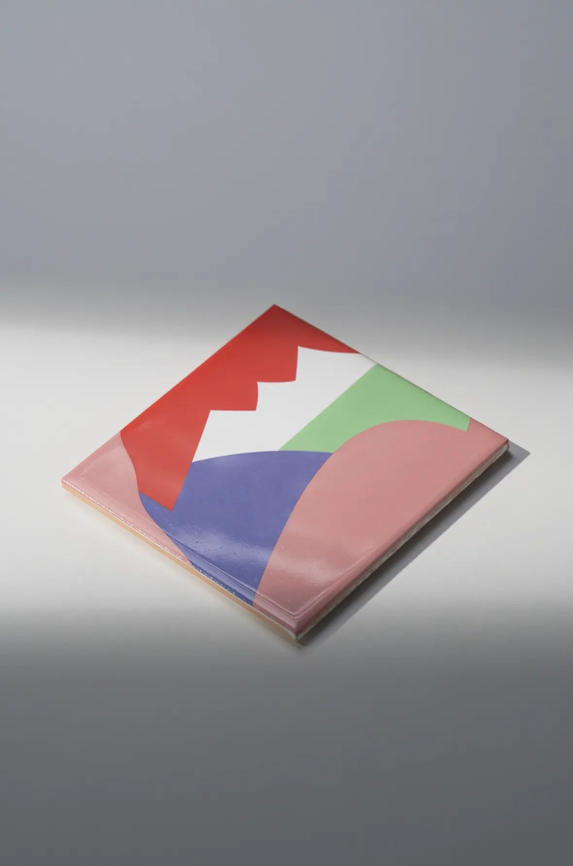 Angled shot of Pattern Aka Corleone ceramic tile by Clay showing overlapping colorful shapes – on sale at Clay