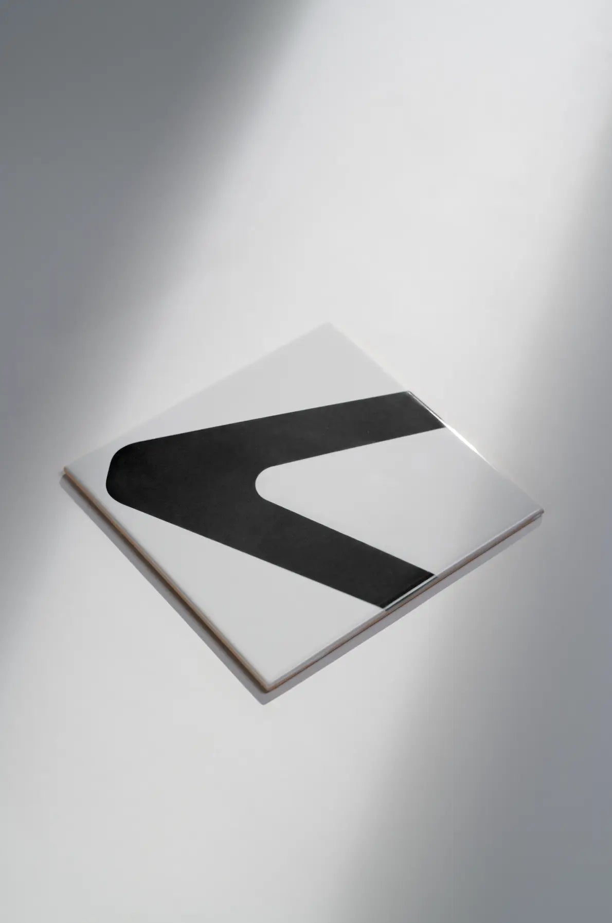 Angled view of Pattern Clay Originals 1 ceramic tile by Clay in black – available on Clay