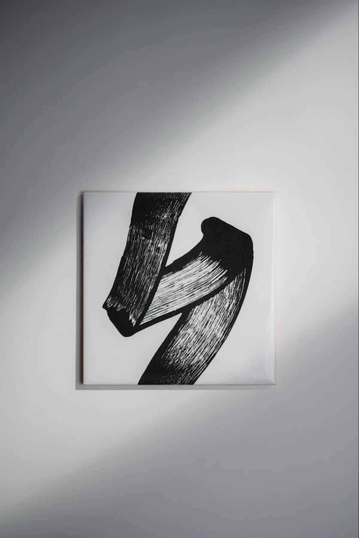 Pattern JonOne ceramic art tile by Clay – black abstract brushstroke design on white, available on Clay