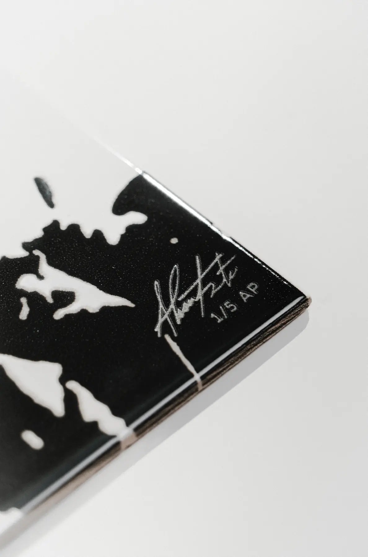 Side profile of Rasura ceramic art tile by Clay with laser engraved artist signature – on sale at Clay