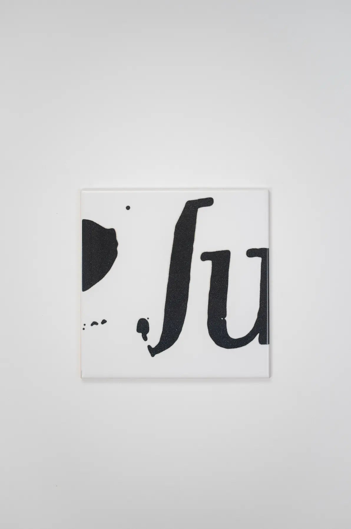 Pattern VHILS ceramic tile by Clay featuring black  typography on white background – available exclusively on Clay